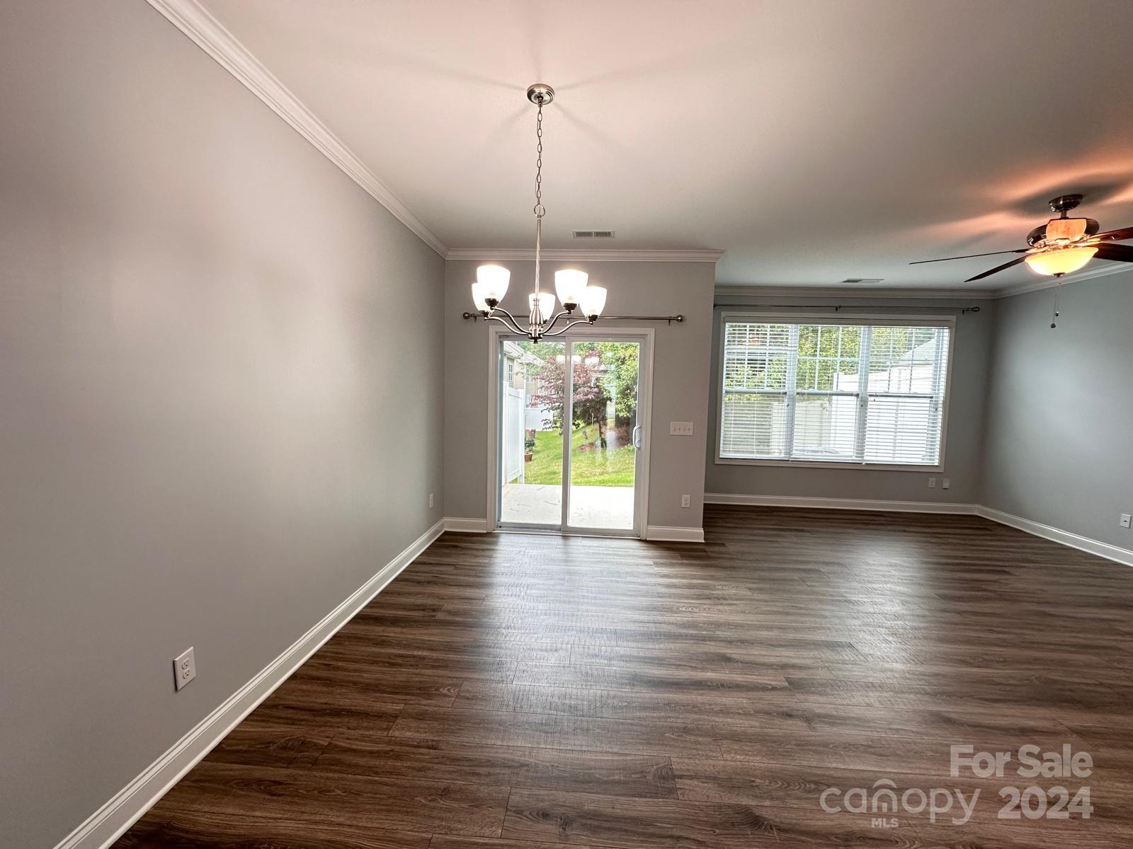 7040 Harris Bay Road Charlotte, NC 28269 - Photo 5 of 27 a view of an empty room with wooden floor and a window