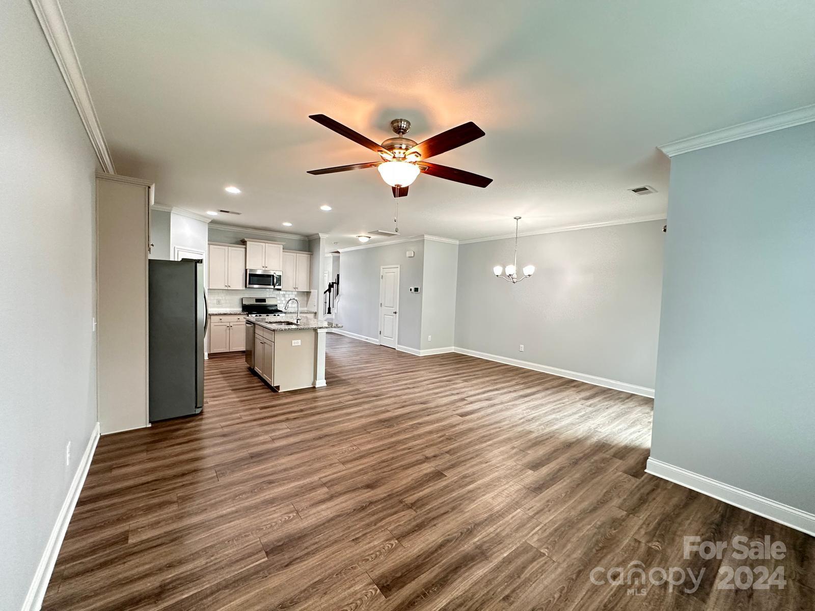 7040 Harris Bay Road Charlotte, NC 28269 - Photo 9 of 27 a view of kitchen with refrigerator stove and wooden floor