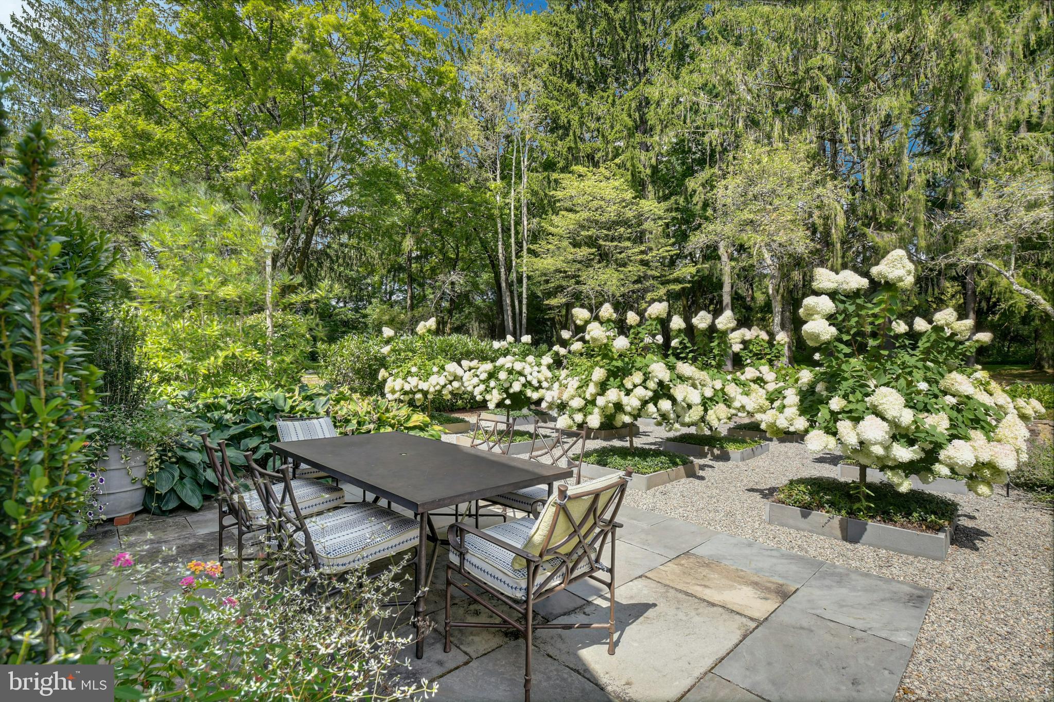 7043 Phillips Mill Road New Hope, PA 18938 - Photo 12 of 84 a view of a backyard with table and chairs and potted plants