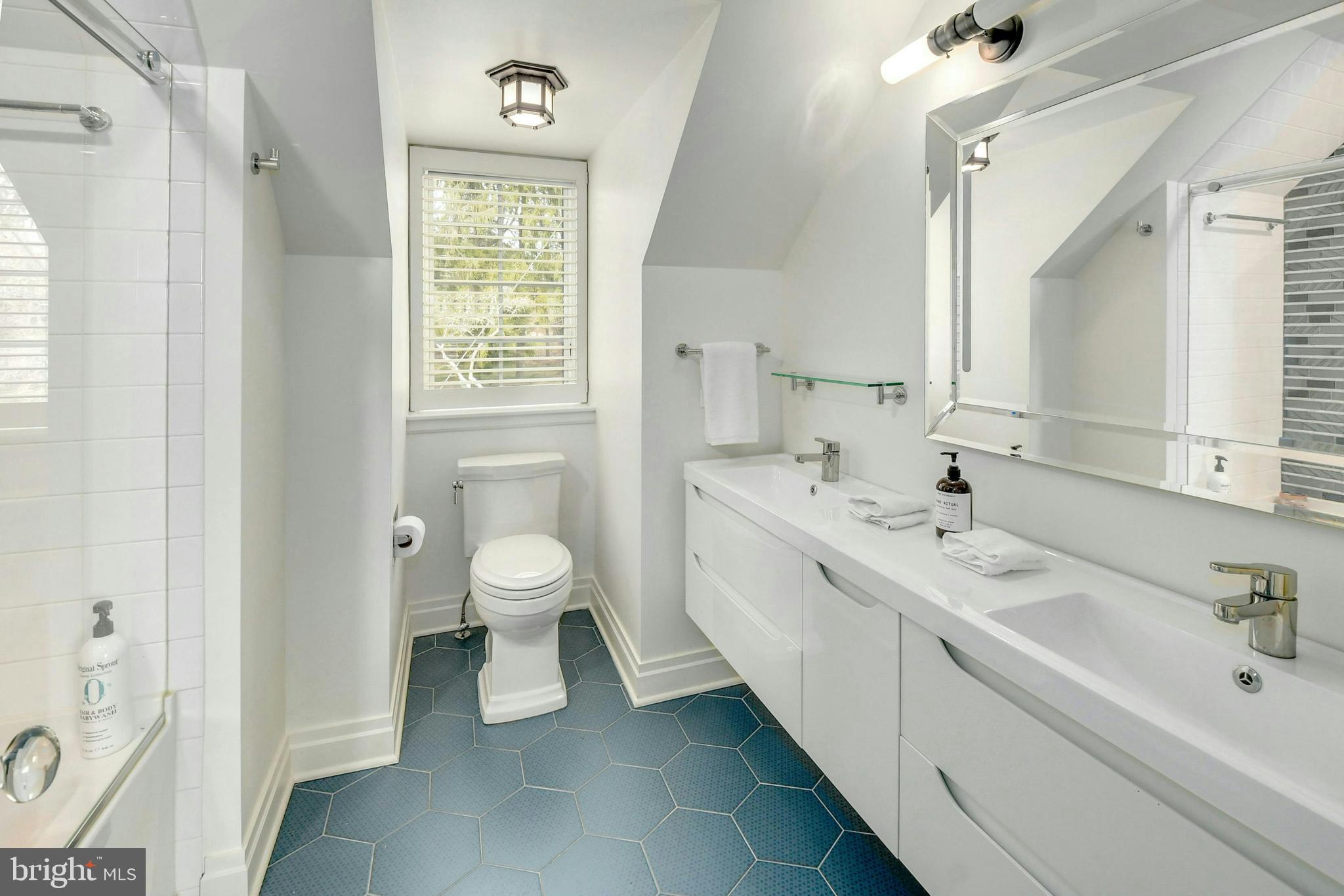 7043 Phillips Mill Road New Hope, PA 18938 - Photo 40 of 84 a bathroom with a toilet sink and mirror