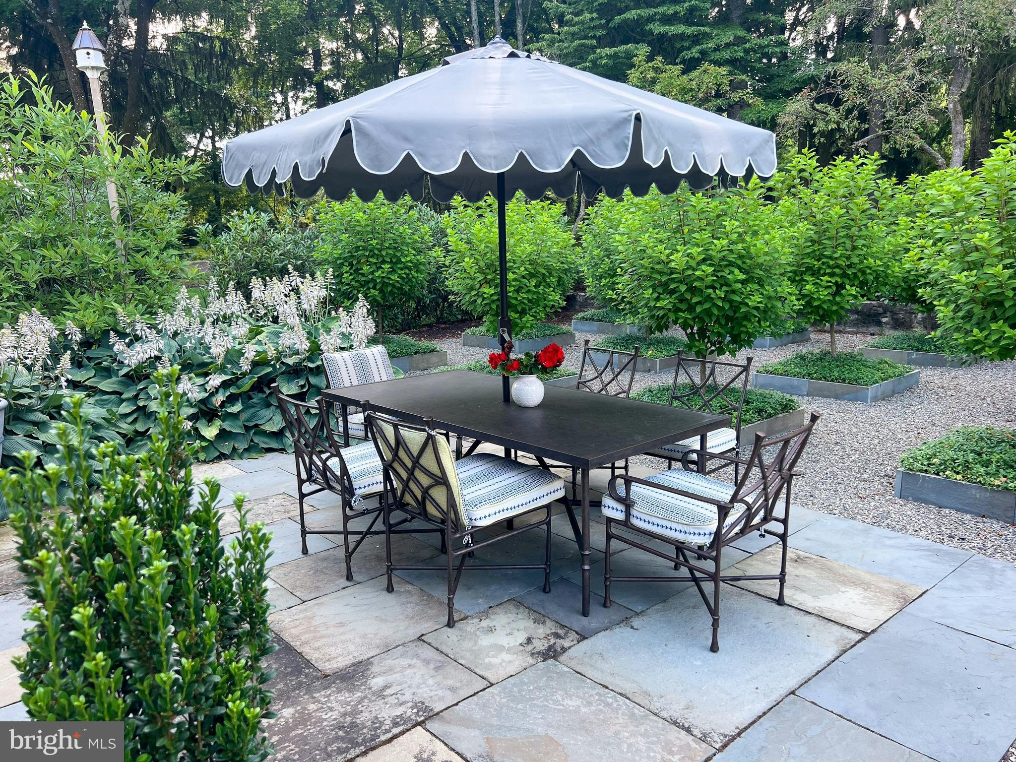 7043 Phillips Mill Road New Hope, PA 18938 - Photo 54 of 84 a backyard of a house with table and chairs under an umbrella