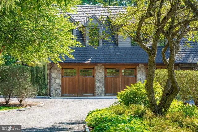 a dining room with furniture a chandelier and wooden floor