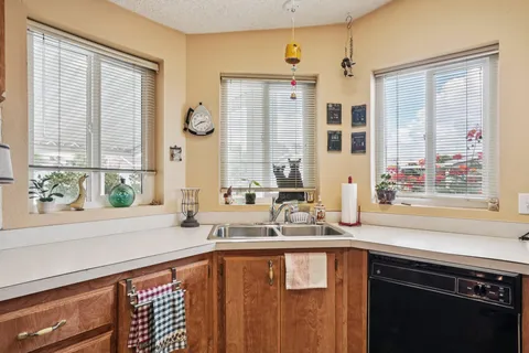 a bathroom with a granite countertop sink and a large mirror