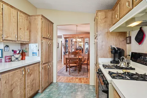 a kitchen with stainless steel appliances a stove a sink and a refrigerator