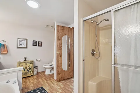 a bathroom with a shower a toilet and a sink