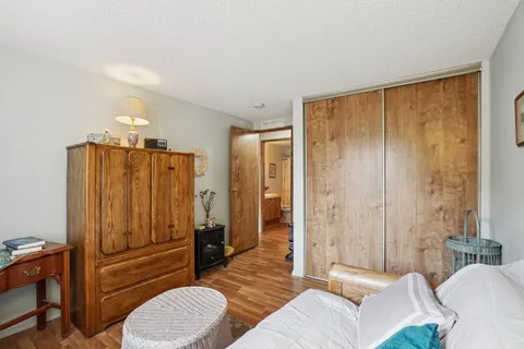 a spacious bedroom with a bed and furniture