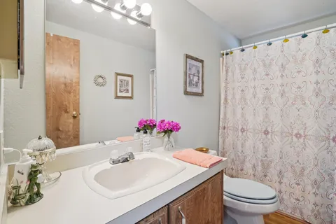 a bathroom with a sink toilet and a mirror