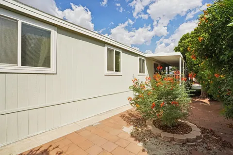 a view of a house with a backyard
