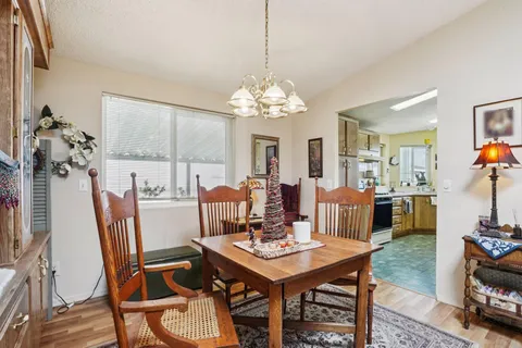 a view of a dining room with furniture and chandelier