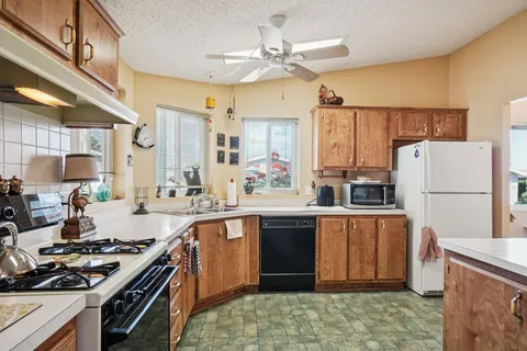 a kitchen with a stove a sink and a refrigerator