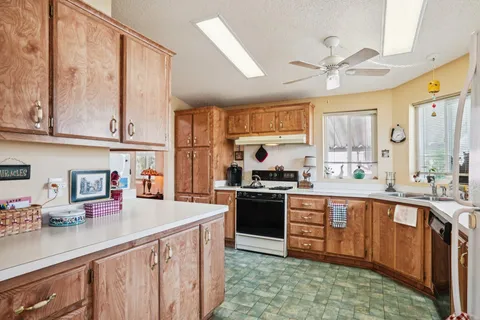a kitchen with stainless steel appliances a sink stove and cabinets