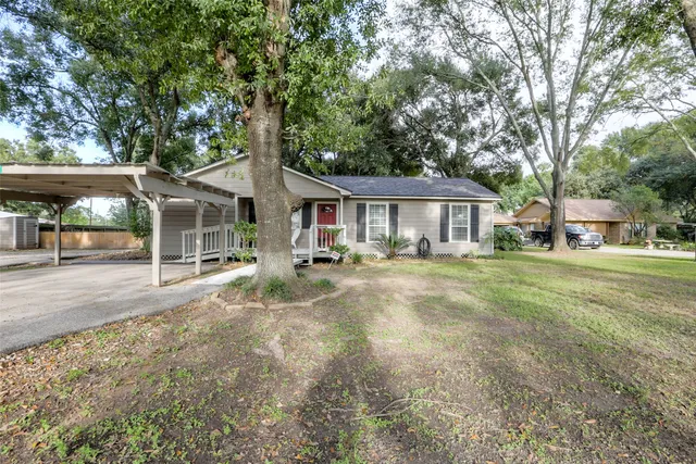 a front view of a house with a yard and table and chairs