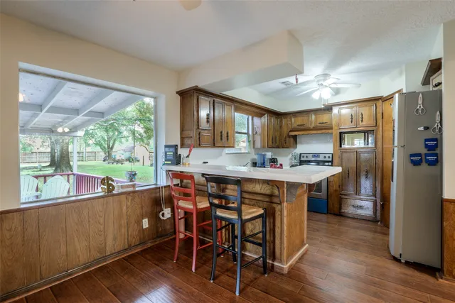a kitchen with a table chairs refrigerator and cabinets