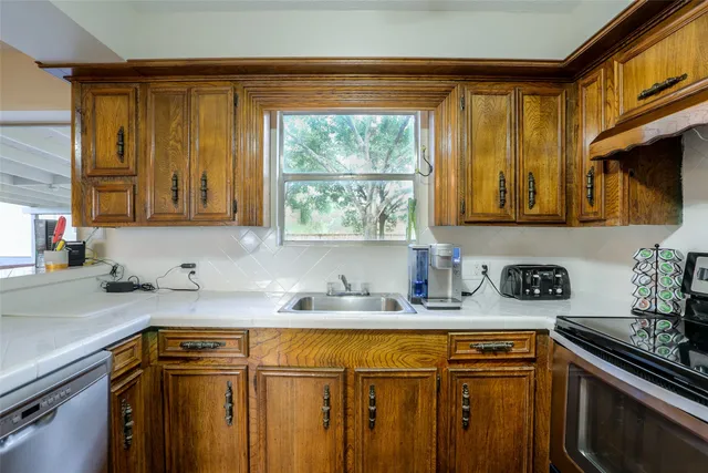 a kitchen with stainless steel appliances granite countertop a sink and a cabinets
