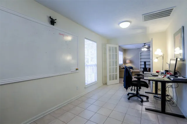 a view of a workspace with furniture and a window