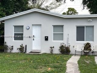 671 Northwest 50th Street, Unit 2 Miami, FL 33127 - Photo 1 of 14 a front view of a house with garden
