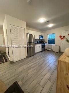 671 Northwest 50th Street, Unit 2 Miami, FL 33127 - Photo 14 of 14 a kitchen with stainless steel appliances granite countertop a refrigerator and a stove