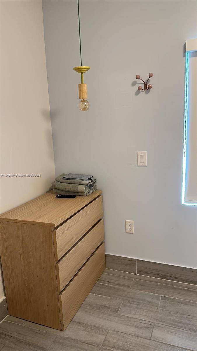 671 Northwest 50th Street, Unit 2 Miami, FL 33127 - Photo 2 of 14 a bathroom with a granite countertop sink and vanity