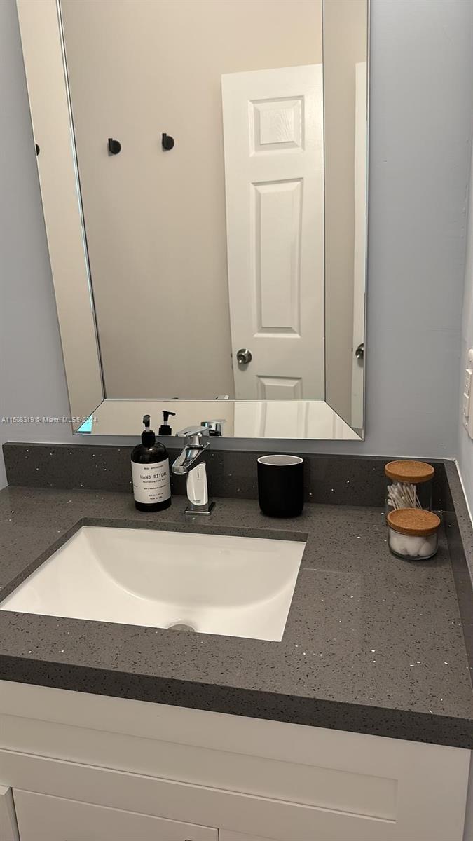 671 Northwest 50th Street, Unit 2 Miami, FL 33127 - Photo 5 of 14 a bathroom with sink and mirror