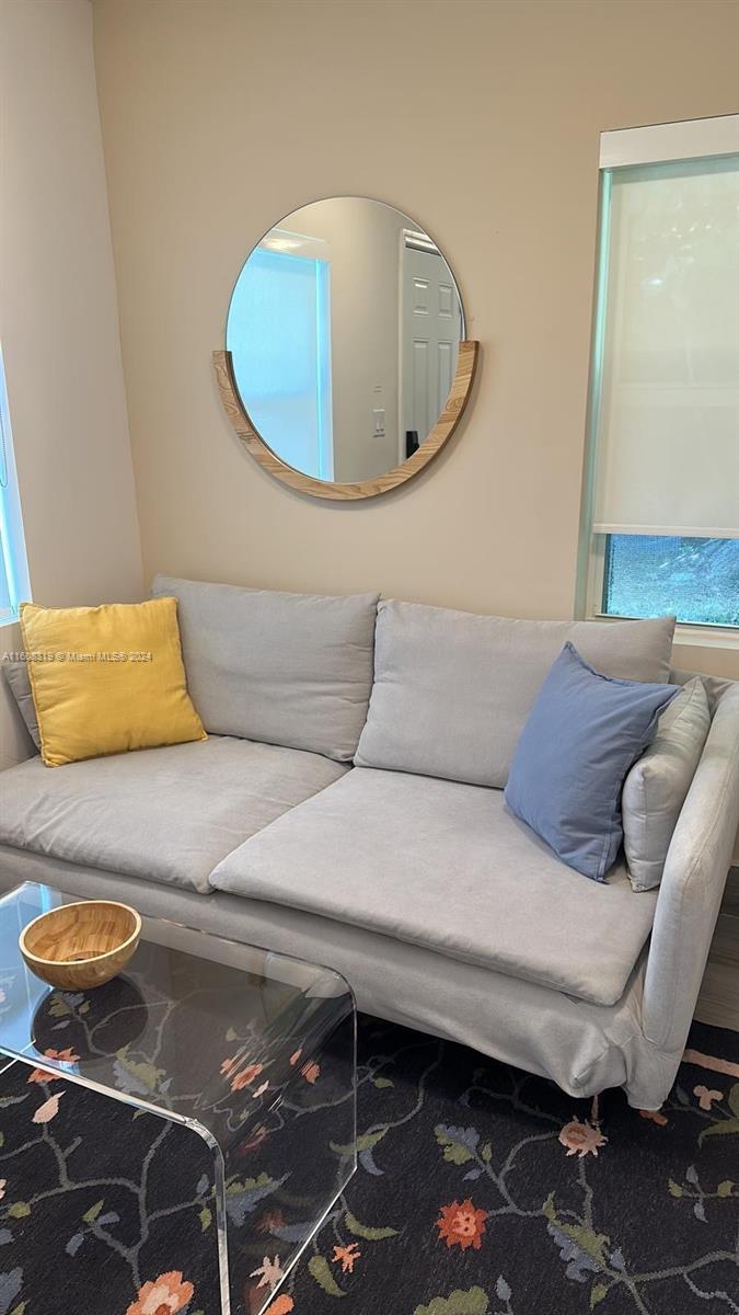 671 Northwest 50th Street, Unit 2 Miami, FL 33127 - Photo 7 of 14 a living room with furniture and a rug