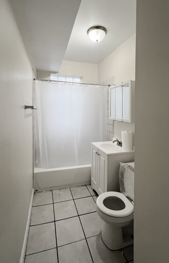 819 West 83rd Street, Unit 1N Chicago, IL 60620 - Photo 6 of 6 a bathroom with a sink toilet and shower