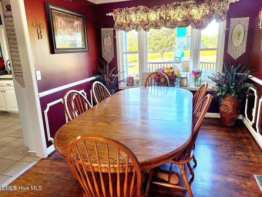 1000 High House Road Clinton, NC 28328 - Photo 11 of 36 a view of a dining room with furniture a chandelier and wooden floor