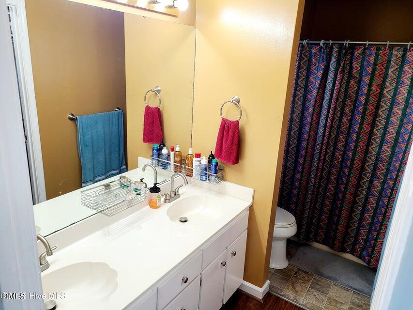 1000 High House Road Clinton, NC 28328 - Photo 16 of 36 a bathroom with a sink vanity and mirror