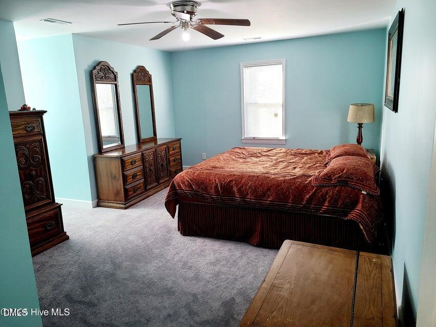 1000 High House Road Clinton, NC 28328 - Photo 18 of 36 a bed sitting in a room next to a window