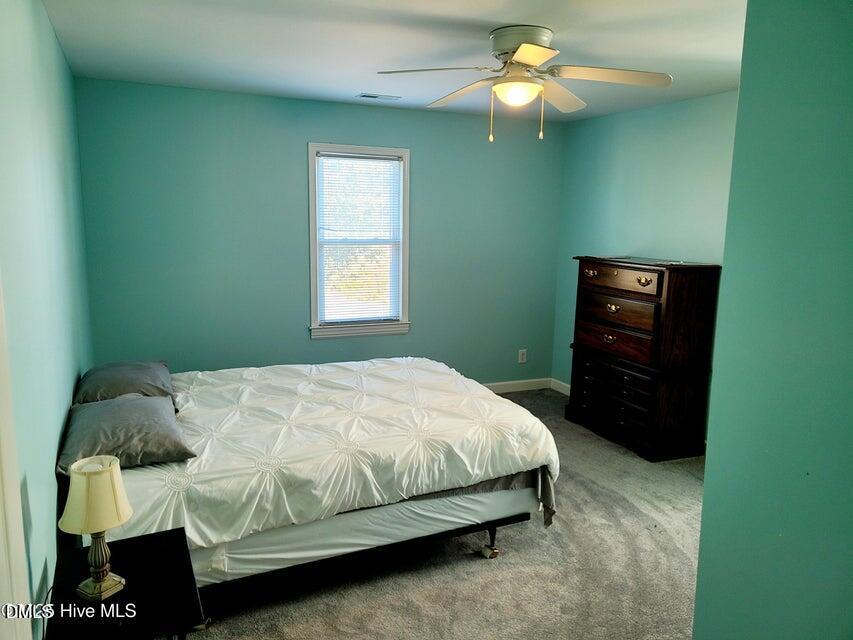 1000 High House Road Clinton, NC 28328 - Photo 20 of 36 a bedroom with a bed and a chandelier