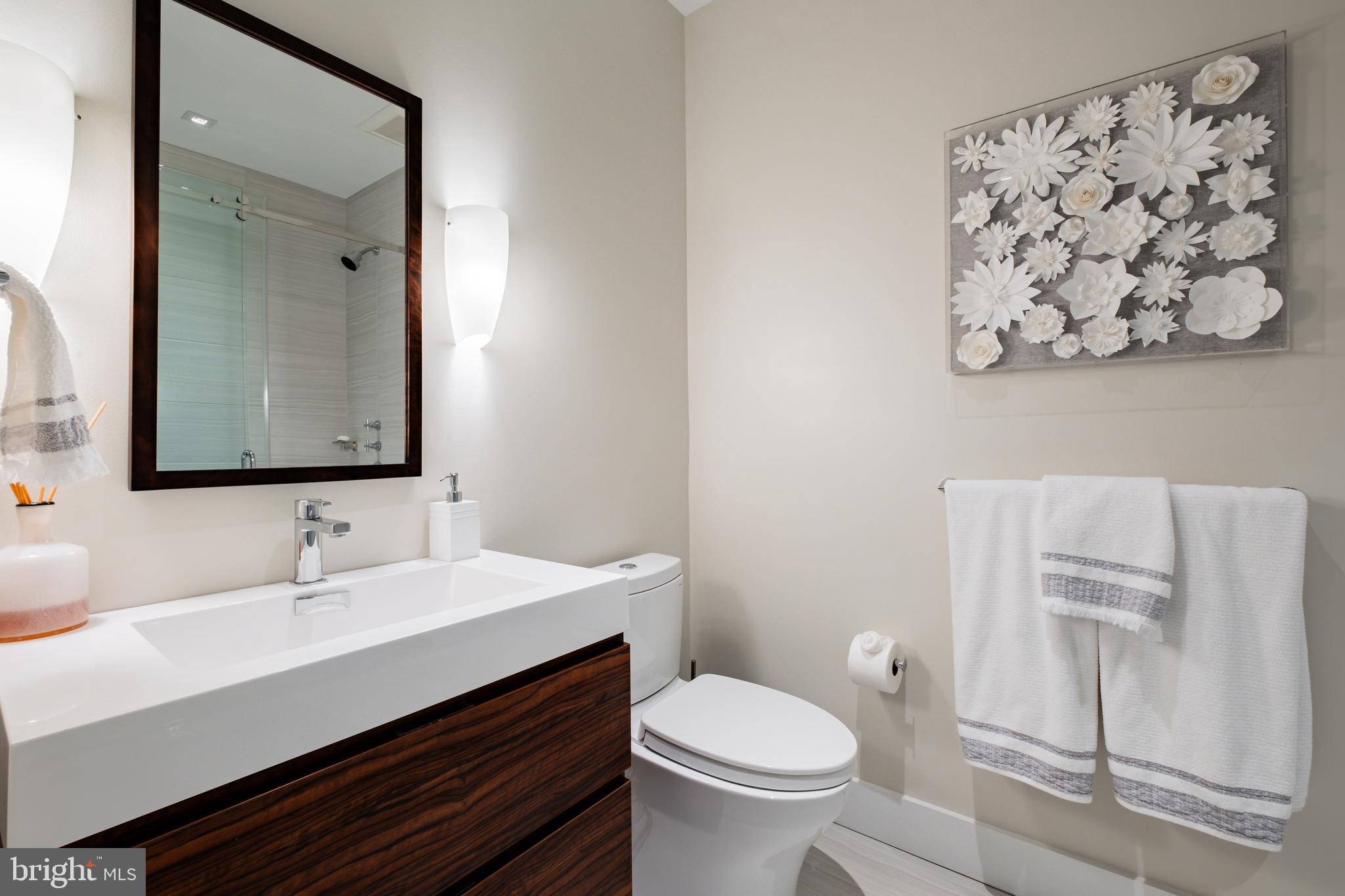 500 Walnut Street, Unit 1001 Philadelphia, PA 19106 - Photo 48 of 60 a bathroom with a sink mirror vanity and toilet