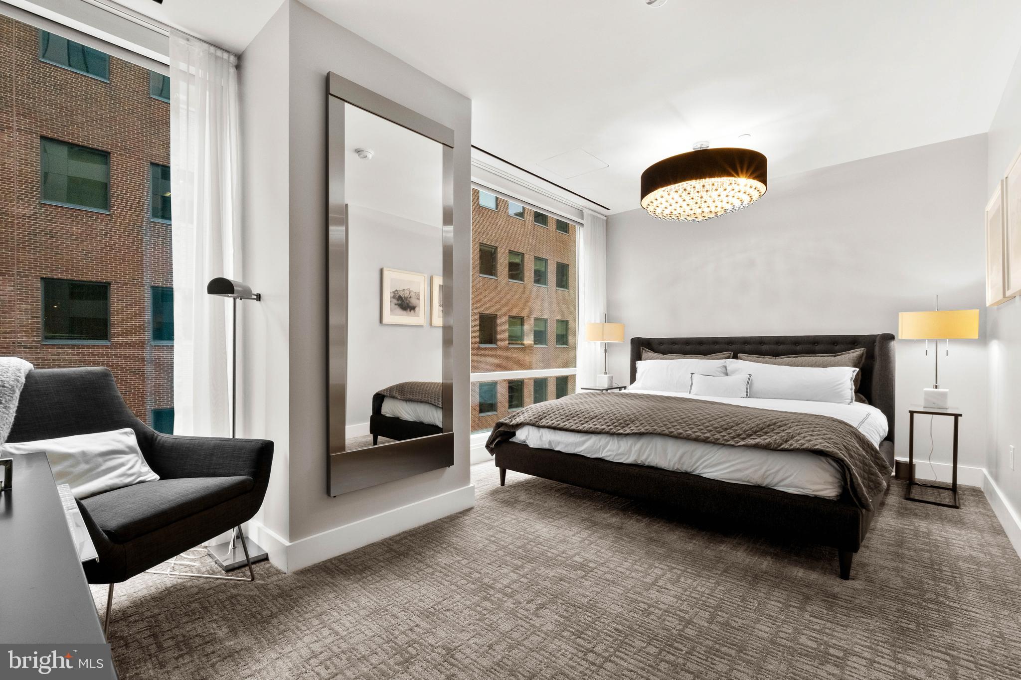 500 Walnut Street, Unit 1001 Philadelphia, PA 19106 - Photo 50 of 60 a spacious bedroom with a bed and glass window