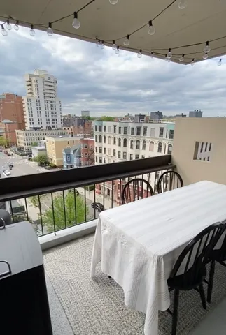 a view of a balcony dining table and chairs