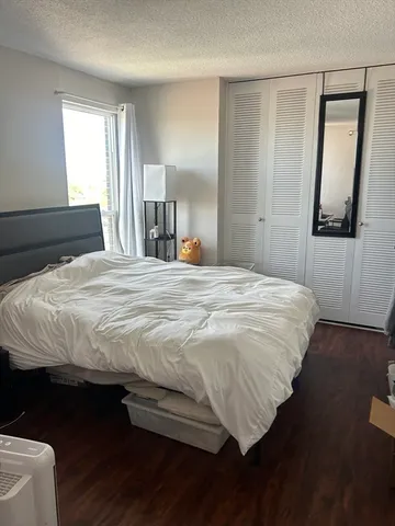 a bedroom with a bed and a mirror