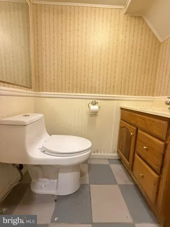 a bathroom with a toilet and a shower curtain