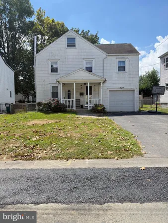 a view of a house with swimming pool and a yard