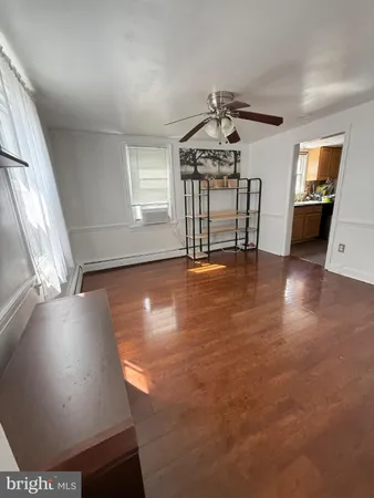 a view of a livingroom with furniture and a kitchen