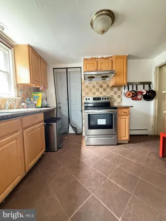 a kitchen with stainless steel appliances a stove a sink and a microwave