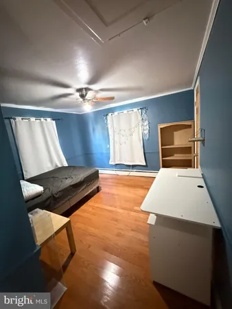 a bedroom with table and window