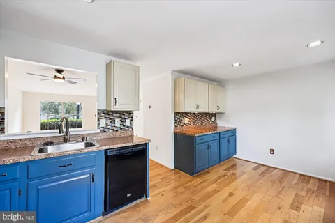 a kitchen with granite countertop a sink and cabinets