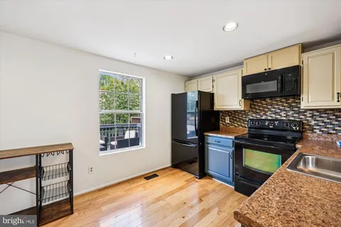 a kitchen with stainless steel appliances granite countertop a refrigerator stove top oven a sink and dishwasher