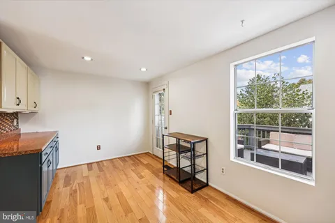 a view of a livingroom with wooden floor and a window