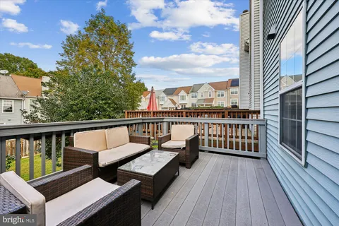 a view of a balcony with wooden floor next to a road