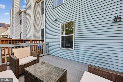 a view of a patio with a table and chairs and wooden floor