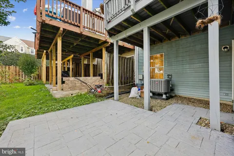 a view of a house with a yard and sitting area
