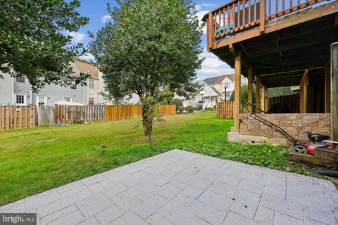 a view of a house with backyard and a tree