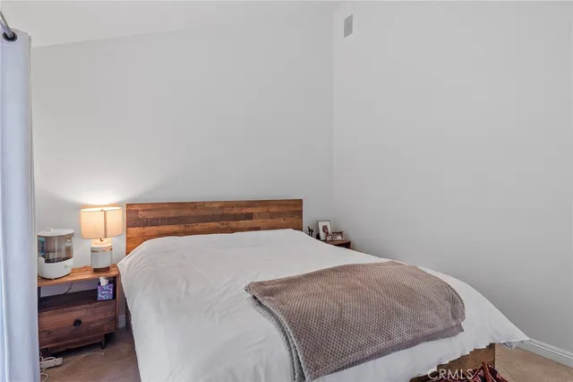 a bedroom with a bed and a large window