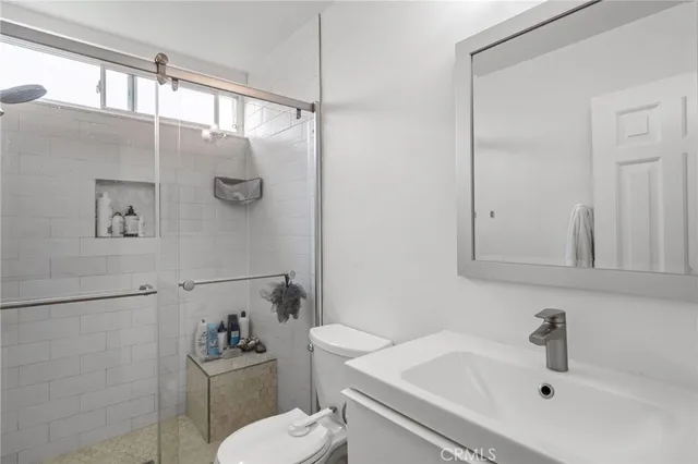 a bedroom with a bed and a mirror