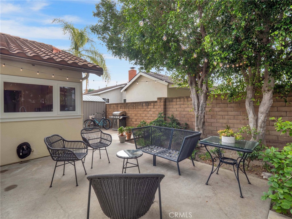 25902 Vía Del Sur Mission Viejo, CA 92691 - Photo 25 of 30 a view of a patio with couches and table and chairs with wooden fence and plants