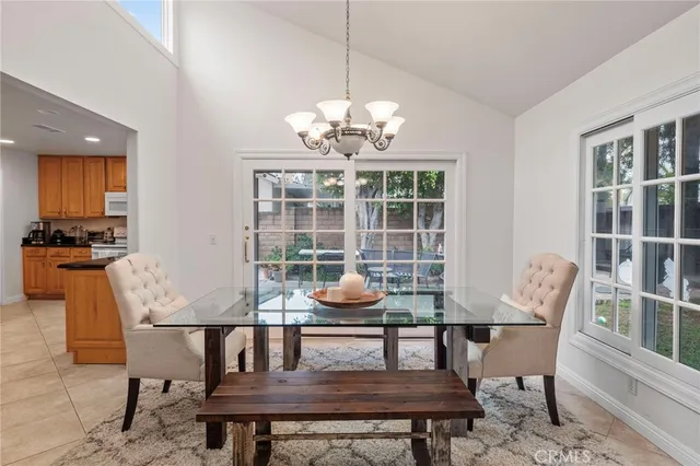 a dining room with furniture a chandelier and wooden floor