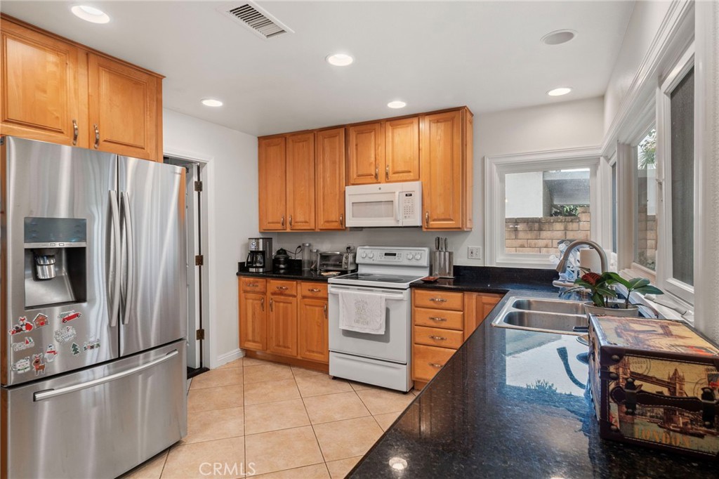 25902 Vía Del Sur Mission Viejo, CA 92691 - Photo 5 of 30 a kitchen with stainless steel appliances a refrigerator sink and cabinets
